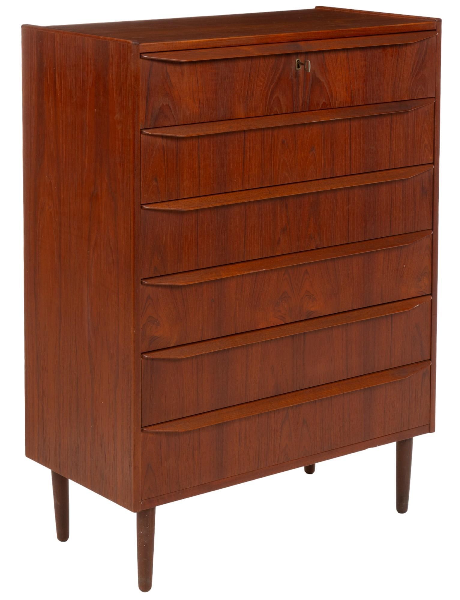 Danish Mid-Century Dresser: Danish mid-century dresser featuring six stacked drawers with wooden pulls, supported on pin legs height 42.5 in. x width 31 in. x depth 16.5 in. Shipping available for this lot through our partner 4C