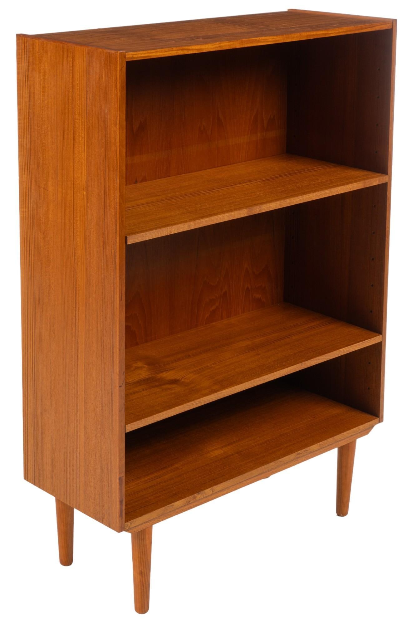 Danish Mid-Century Bookshelf: Danish mid-century bookshelf with three shelves, supported on tapered legs height 46.5 in. x width 32 in. x depth 13 in. Shipping available for this lot through our partner 4CL; please request a shipp