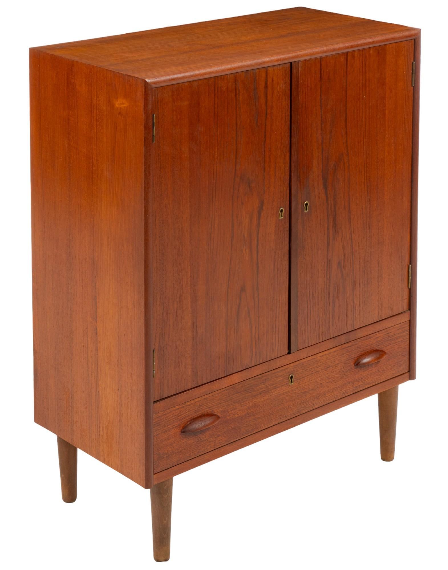 Danish Mid-Century Side Cabinet: Danish mid-century side cabinet featuring central cabinet with two drawers and one shelf, some lined, one lower drawer, on pin legs height 30 in. x width 28.5 in. x depth 15 in. Shipping available