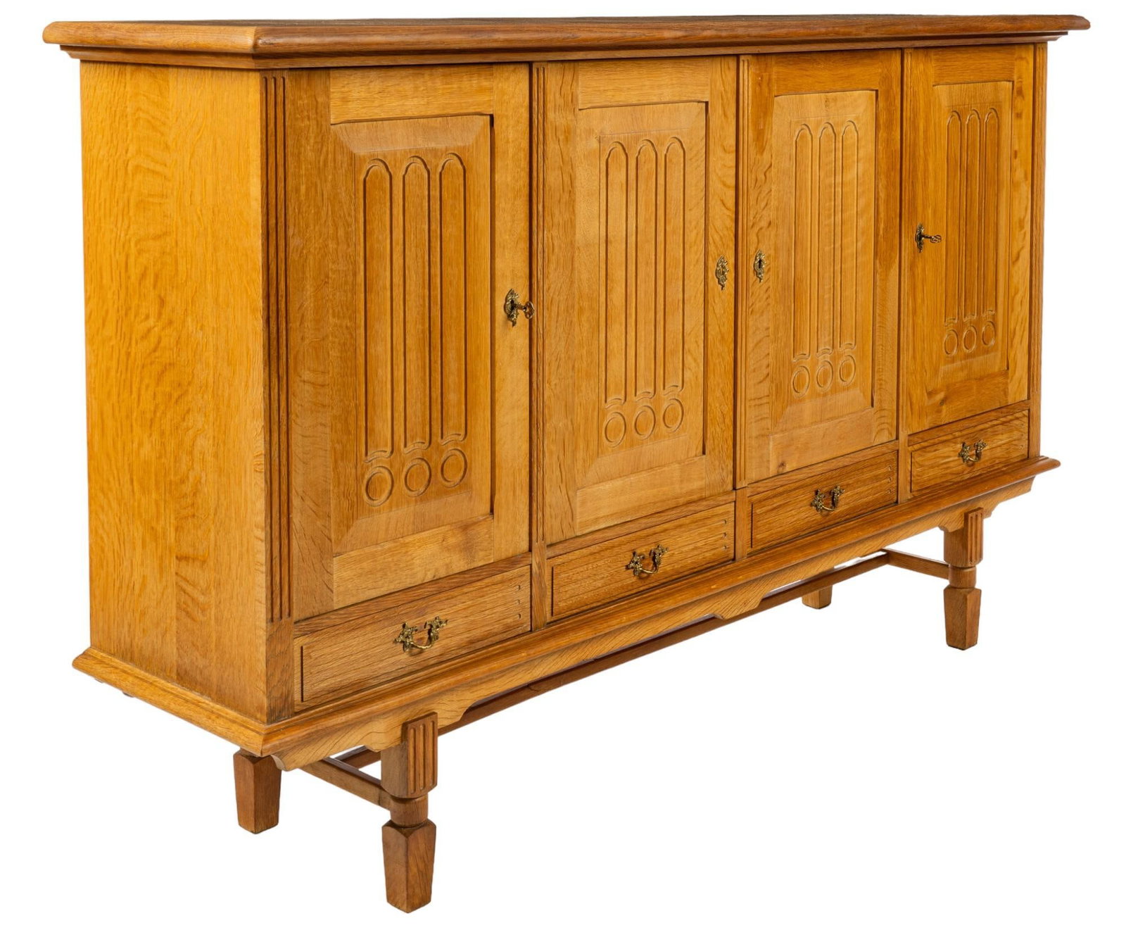 Henning Kjaernulf (DNK) Mid-Century Credenza: Mid-century oak credenza after Henning Kjaernulf (Denmark) featuring oversized top above four drawers with carved accents, three drawers reveal interior with two shelves, leftmost drawer opens to inte