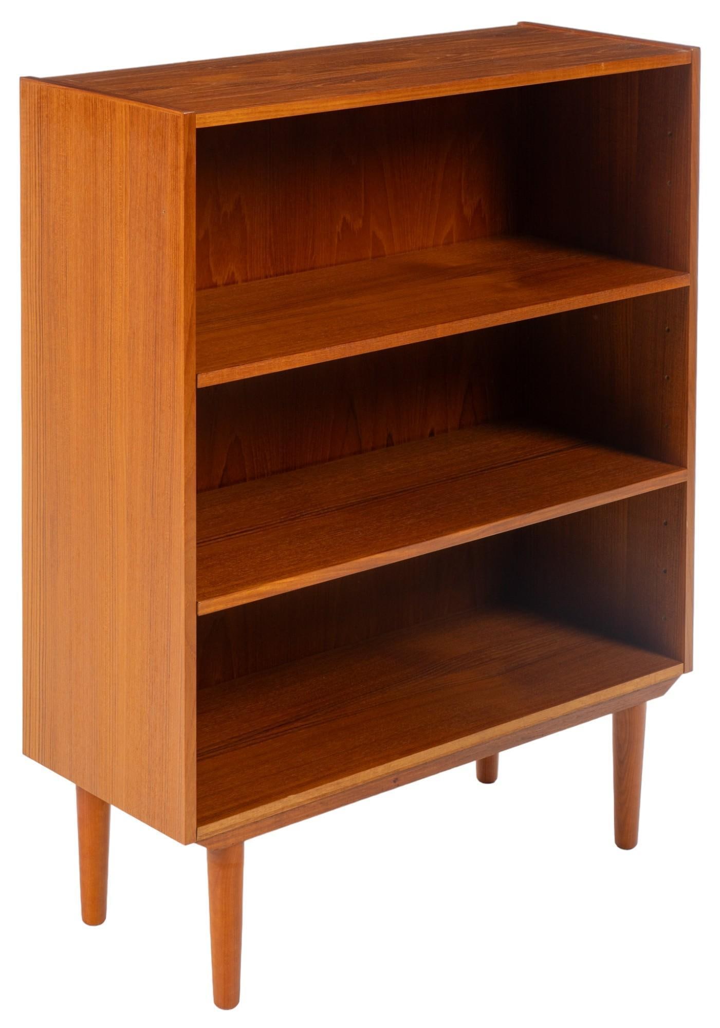 Danish Mid-Century Bookshelf: Danish mid-century bookshelf, with two adjustable shelves, supported on pin legs height 42 in. x width 32 in. x depth 13 in. Shipping available for this lot through our partner 4CL; please request a s