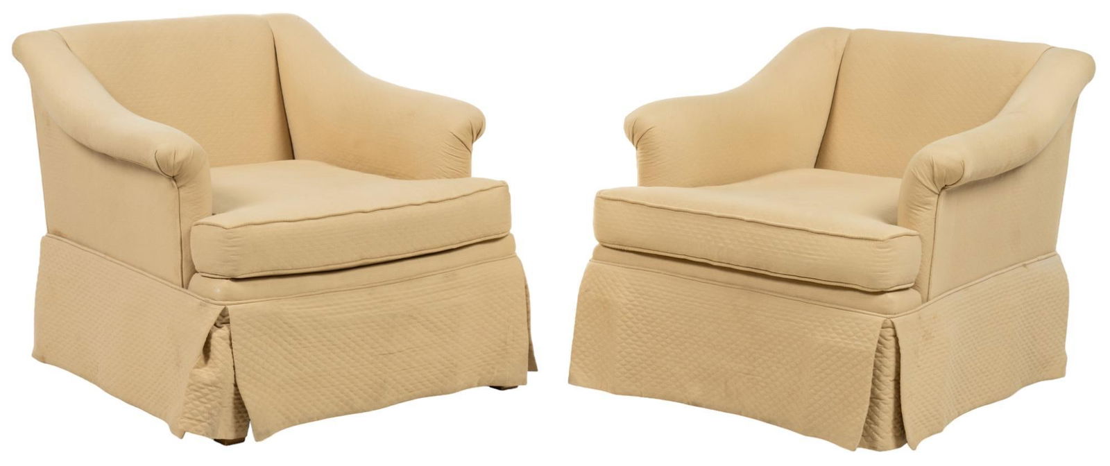 Pair of Arm Chairs: Pair of cushioned arm chairs featuring sloping armrests, with light yellow fabric upholstery, and dust skirts, supported on wooden block legs height 27 in. x width 28 in. x depth 38 in. / each Pro
