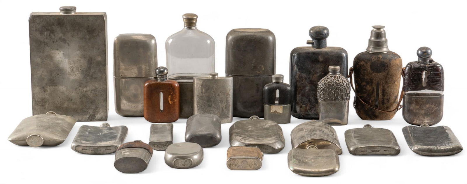(23) Vintage Flasks: Collection of twenty-three vintage metal flasks, with various sizes and styles included, with some featuring leather accents height 8.5 in. x width 4 in. x depth 1 in. Provenance: The collection o