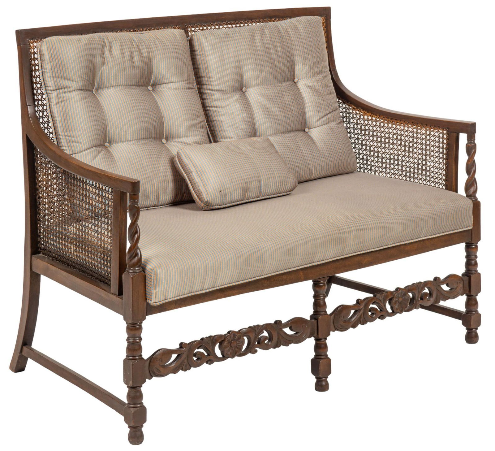 Cane Settee: Wooden settee featuring caned back and sides, sloping armrests ending in twisting supports, above turned front legs with carved front stretcher with botanical motif, with removable pillows, and cushio
