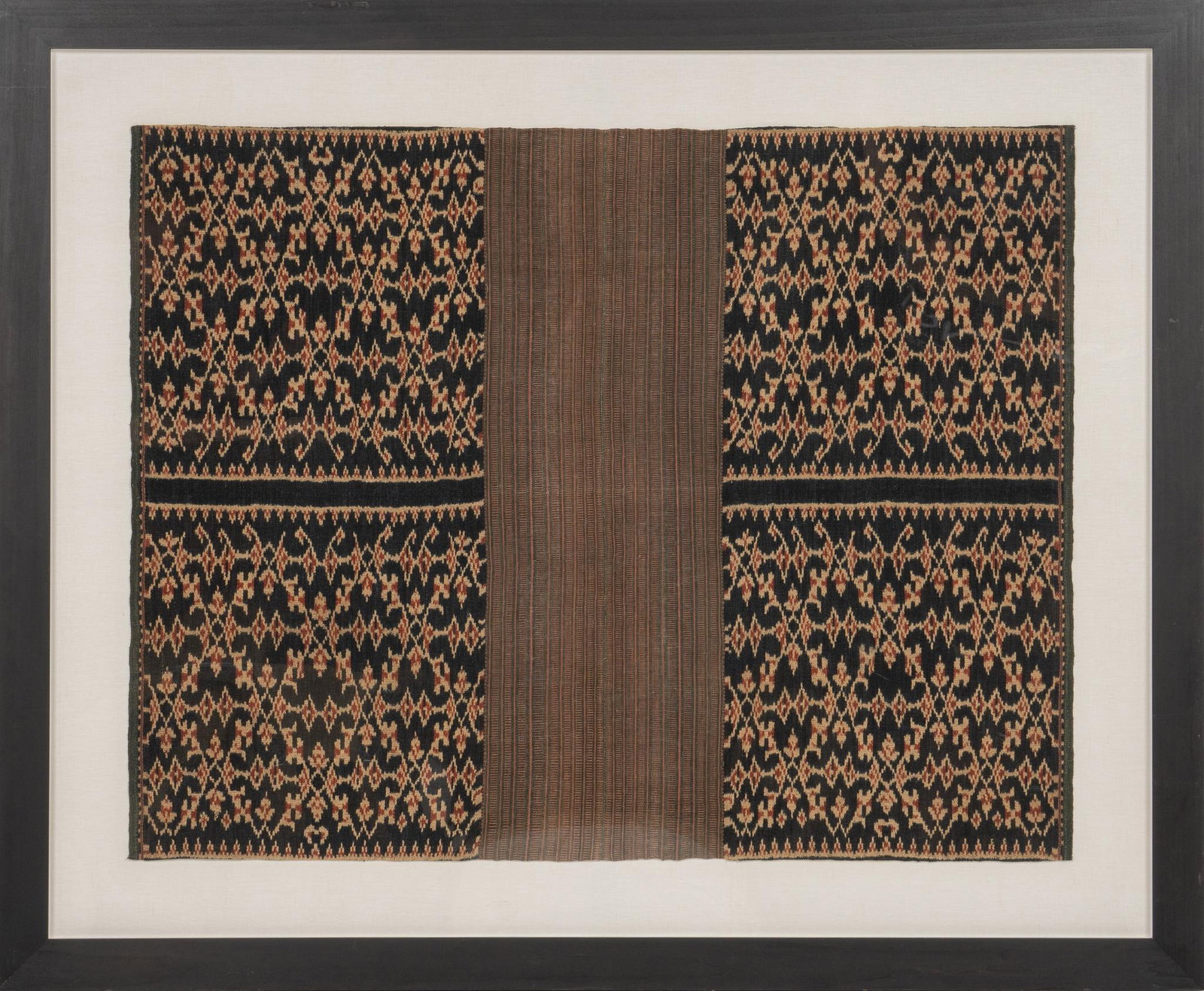Framed Handwoven Indonisian Textile: Handwoven Ikat (Indonisia) textile, 20th century, floated under plexi glass, framed height 65 in. x width 79 in. Shipping available for this lot through our partner 4CL; please request a shipping quot
