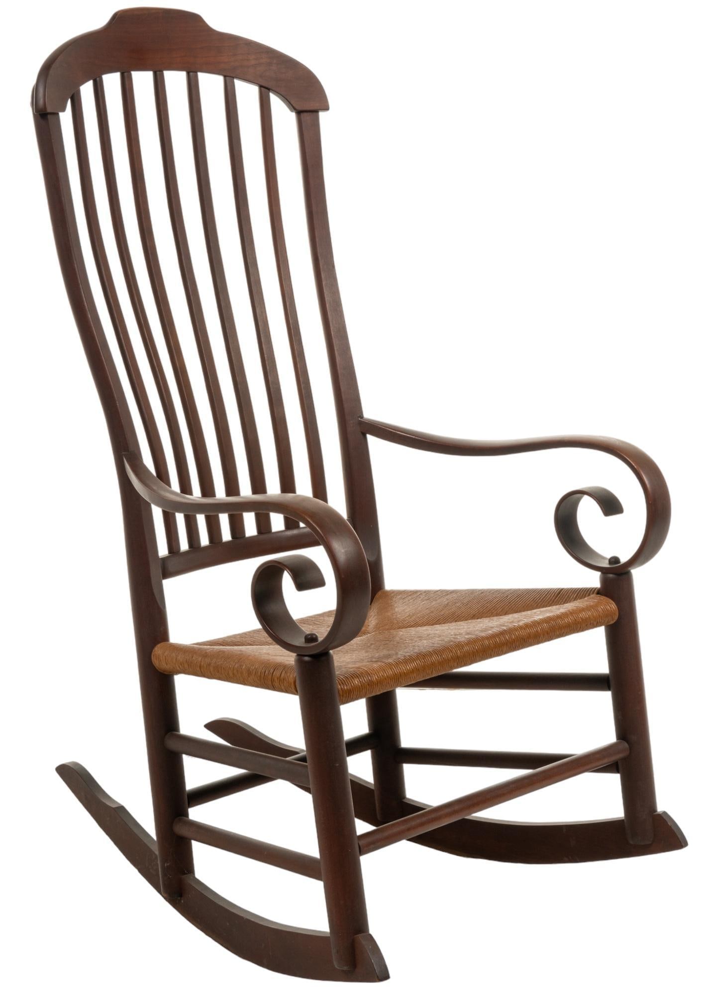 Thrush Rocking Chair: Wooden rocking chair featuring gently sloping ribbed back, thrush seat, and scrolled arms height 45 in. x width 24 in. x depth 30 in. Provenance: Property from the home of a San Antonio, Texas lady Sh