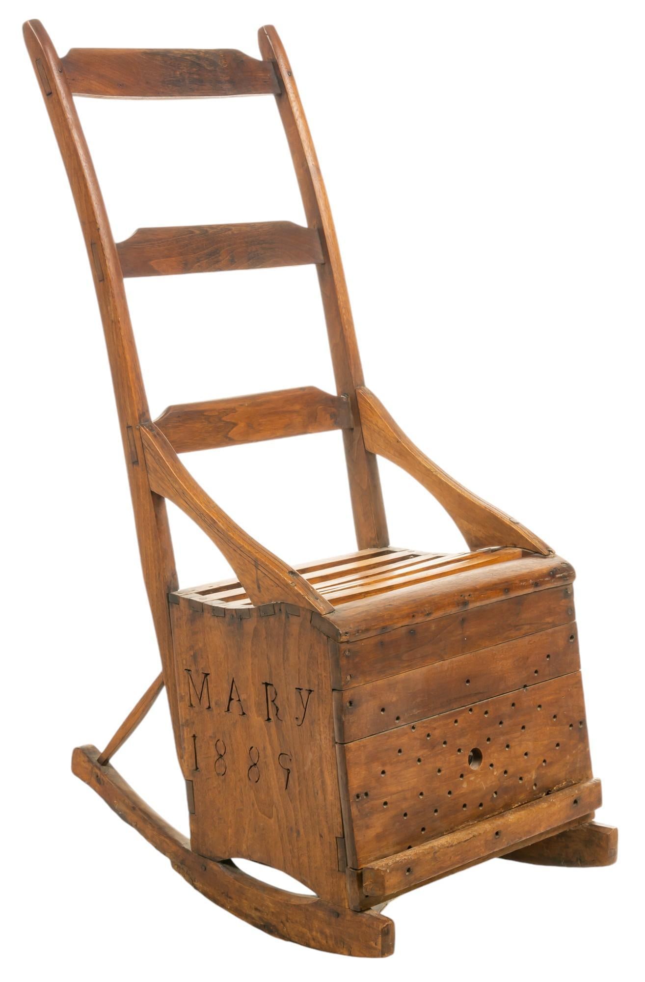 Vintage Wooden Rocking Chair, 1889: Wooden rocking chair with pull out foot rest, with "Mary 1889" on one side and "Eliza Willia" on the other, featuring a hollowed area under seat for storage height 43.5 in. x width 18 