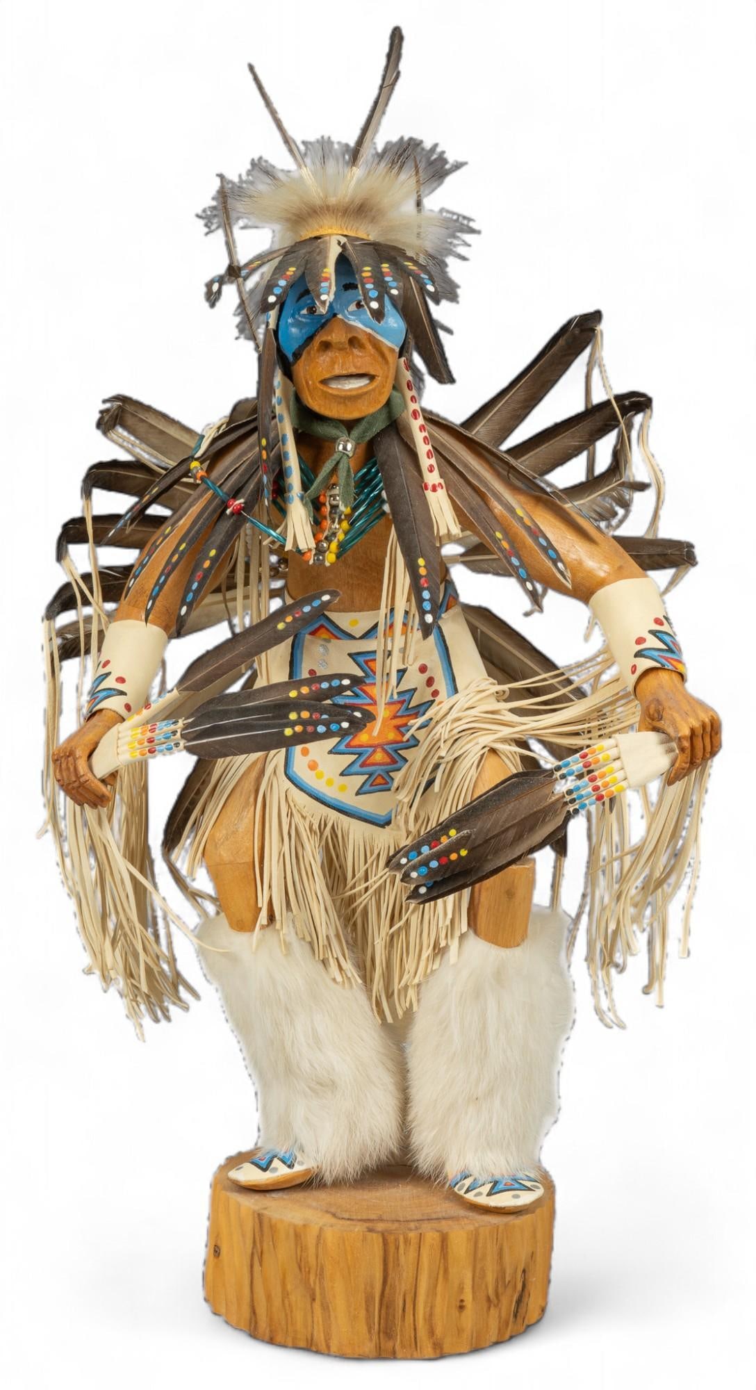 Navajo Wooden Figurine: Navajo wooden figuring featuring polychome accents and feathers height 20 in. x width 10 in. x depth 6.5 in. Condition: Some feathers broken Shipping available for this lot through our partner 4CL;