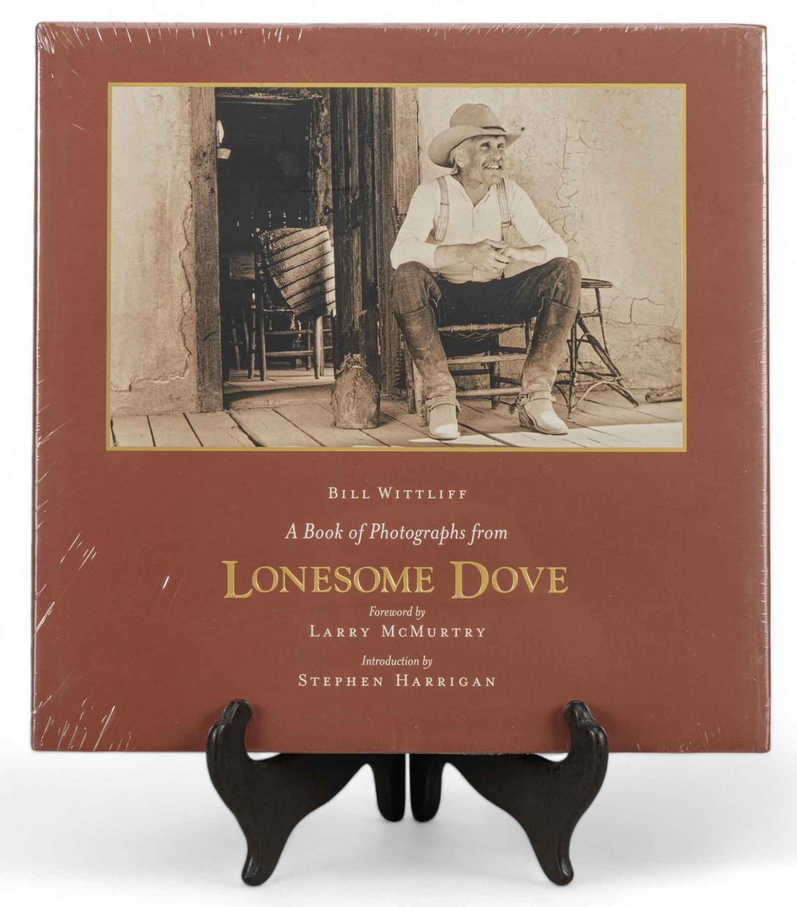 Sealed Copy of Lonesome Dove Photograph Book: Sealed copy of A Book of Photographs from Lonesome Dove by Bill Wittliff, originally published in 2007 height 12.25 in. x width 12.25 in. x depth 1 in. Shipping available for this lot through our part