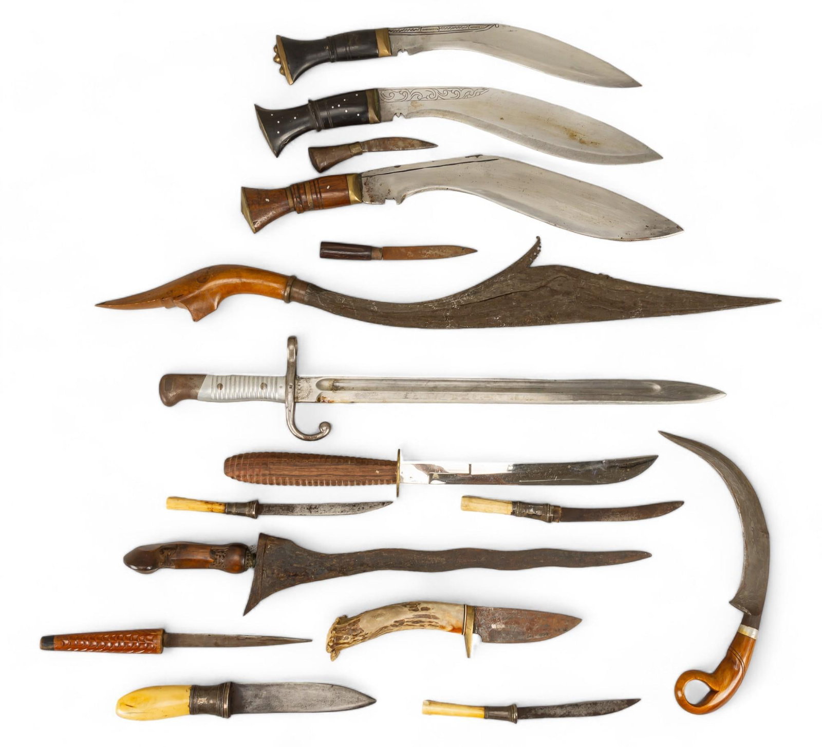 Collection of (15) Exotic Weapons: Collection of exotic bladed weapons, includes three kuri knives, one korambit sword, one kris sword, along with several knives that feature animal bone and antler handles, with varying degree of condi