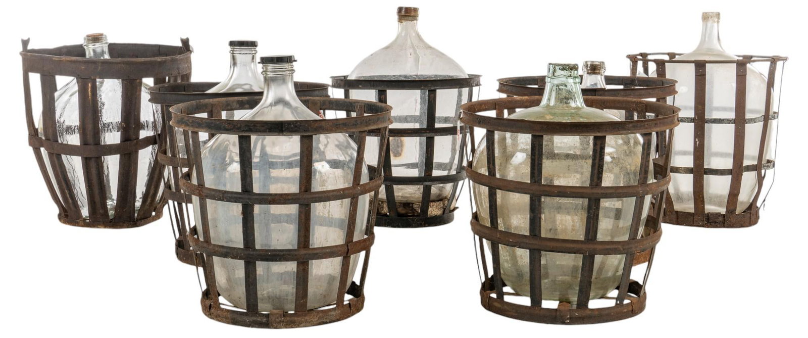 Set of (7) Demijohns with Metal Baskets: Collection of seven glass carboys / demijon in iron baskets height 25 in. x width 24 in. x depth 24 in. / largest ???????Shipping available for this lot through our partner 4CL; please request a shipp