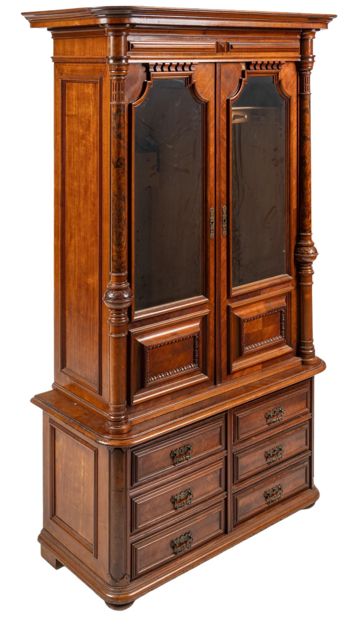 19th C. Victorian Gun Cabinet: Late 19th century Victorian gun cabinet, walnut frame, with crown above pair of paneled glass doors with metal escutcheon that open to interior with left-side having 5 metal hooks, and space to store