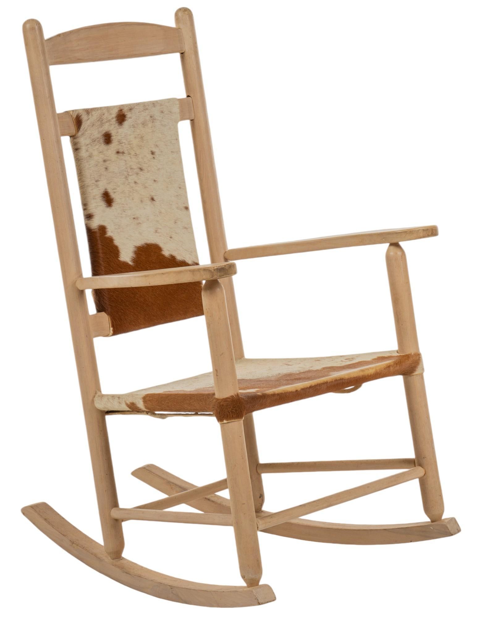Wooden Hide Rocking Chair: Wooden rocking chair with hide on seat and seat back, with foot rest height 41 in. x width 25 in. x depth 30 in. Provenance: Property from the collection of a Corpus Christi, Texas gentleman Shipping 