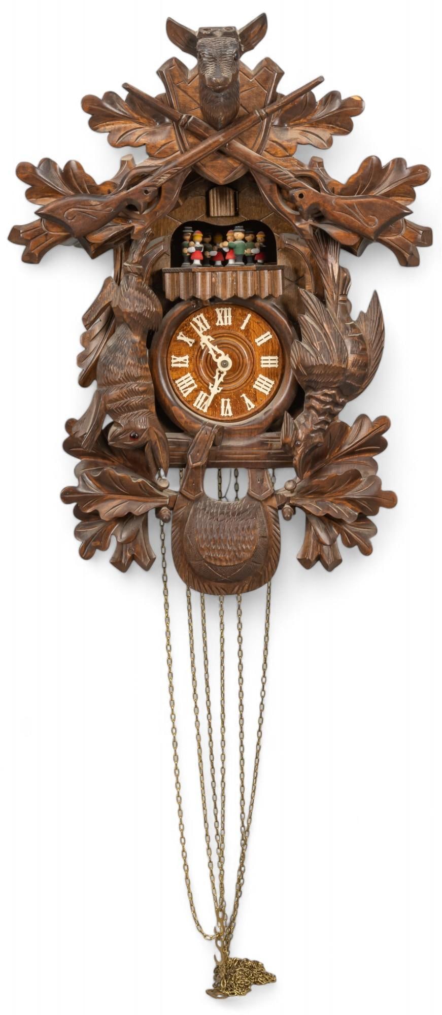 Wall Hanging Hunters Cuckoo Clock: Hunting themed Black Forest style cuckoo clock with deer and gun motifs at top, surrounded by carved oak leaves, rabbit and bird figures flank the clock face height 20.5 in. x width 15 in. x depth 10