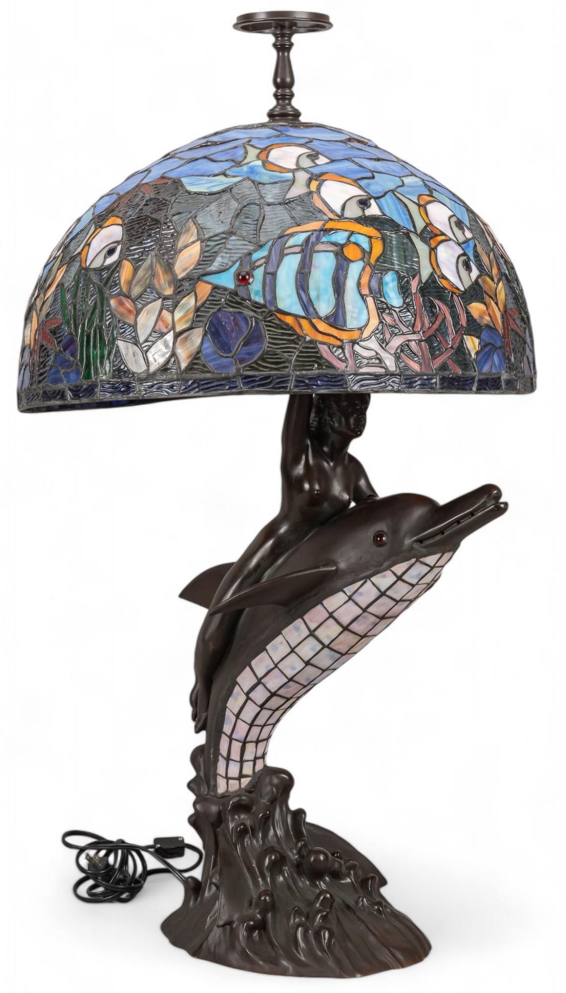 Nautical Colored Glass Lamp: Nautical themed lamp, with bronze base depicting nude female figure riding a dolphin and holding a shell that connects to light fixture, includes colored glass lampshade with fish and seaweed motifs h