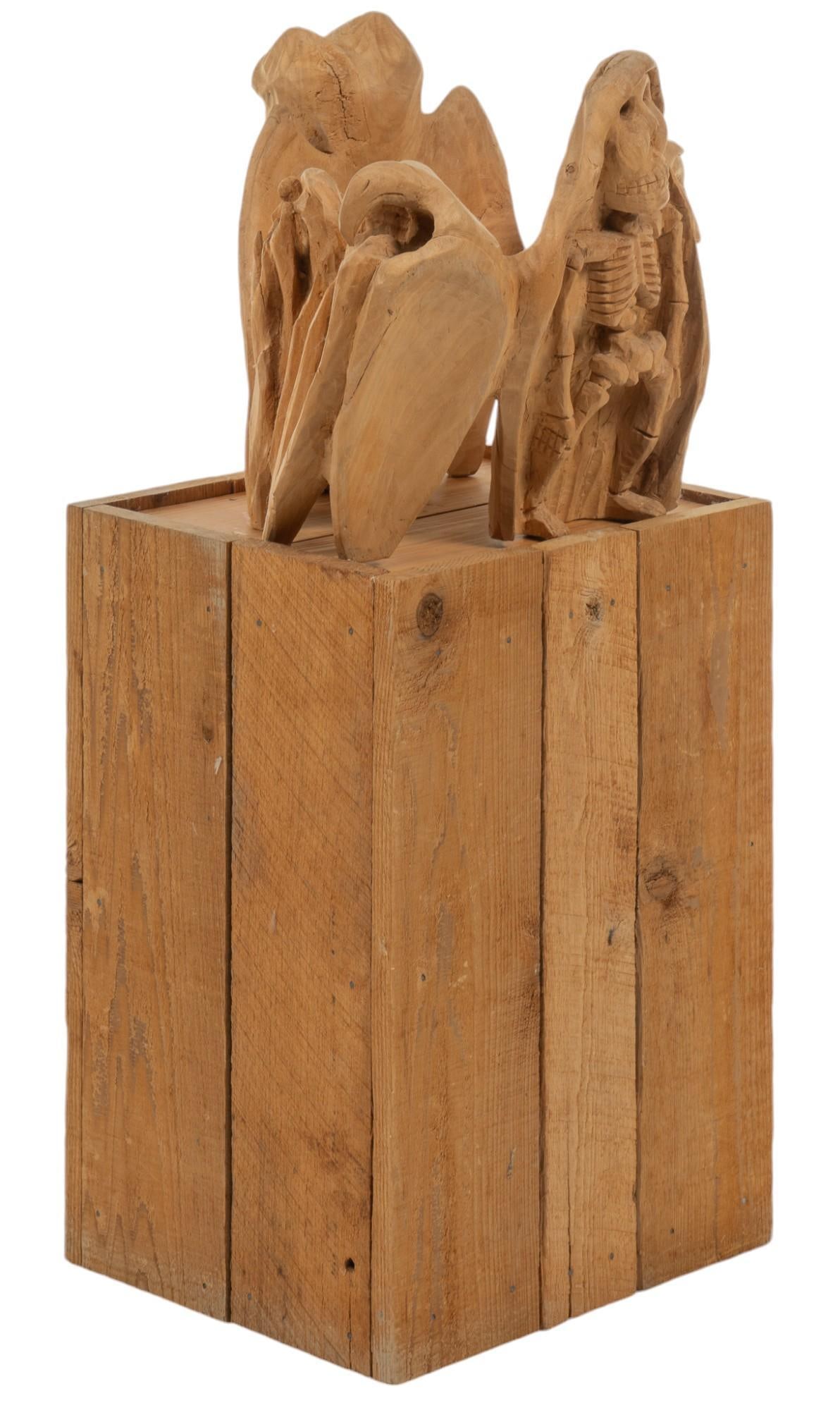 Oaxacan Carved Sculpture with Stand: Oaxacan (Mexico) wood carved sculpture depicting calavera motif, eagle motif, owl motif, and a figure, with custom made base of paneled wood height 33.5 in. x width 17 in. x depth 12.5 in. Provenanc