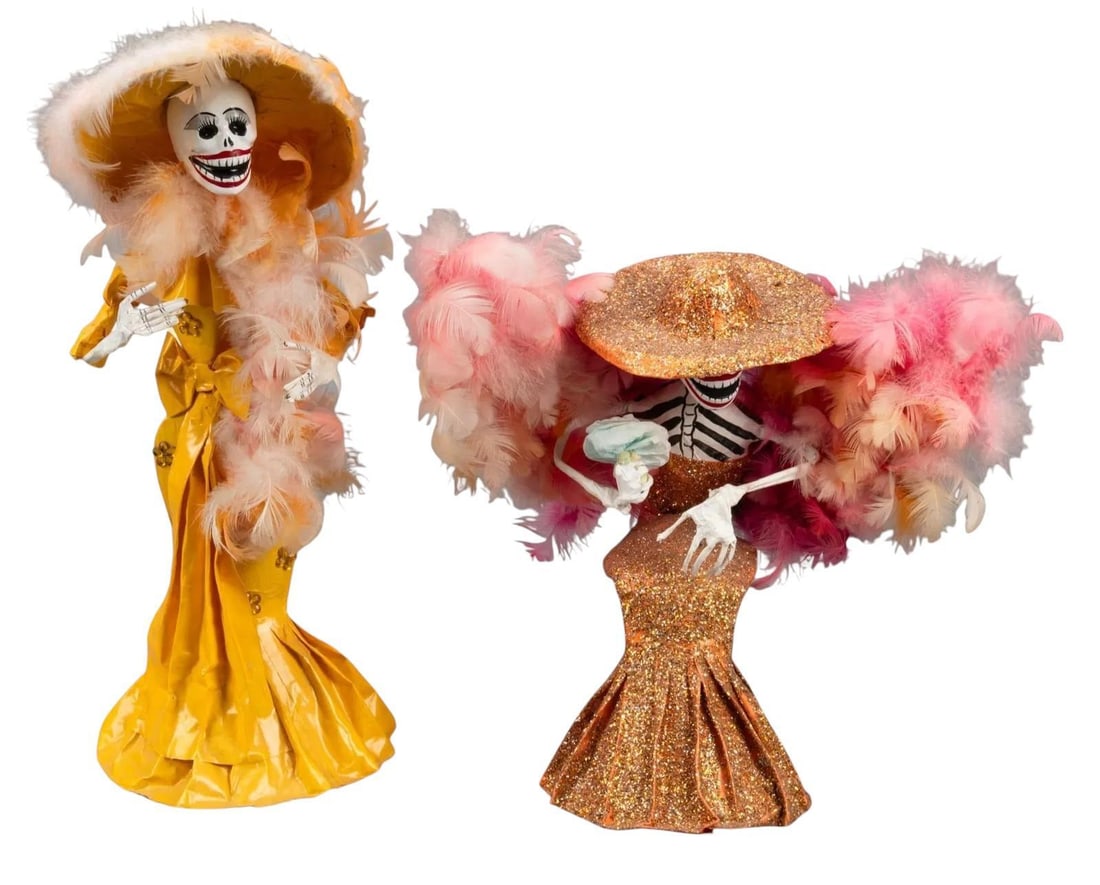 Pair of Papier-Mache Catrinas: Pair of Mexican folk art papier-mache catrinas, with painted accents, feather accents height 17.5 in. x width 6 in. x depth 6.25 in. Provenance: Property from an Austin, Texas collection We happily pr