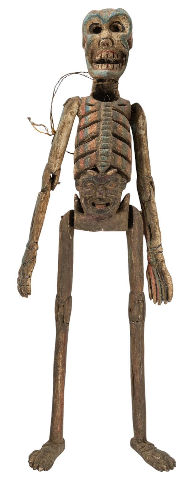 Large Day of the Dead Calavera: Day of the Dead folk art calavera, carved wood with paint remnants, depicting face below rib cage, with rope around neck for display height 28.5 in. x width 9 in. x depth 6 in. Provenance: Property fr