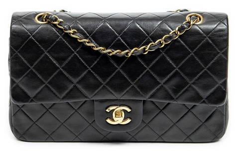 Chanel Classic Double Flap: Chanel Classic Double Flap shoulder bag of black quilted lambskin leather, with interlaced chain and black leather straps, and golden hardware; marked 3415176 (1994-1996) 10 in. x 6 in. x 3 in. 