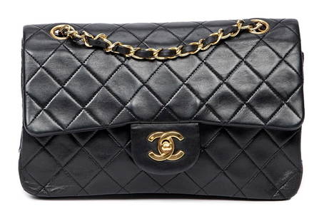 Chanel Classic Double Flap: Chanel Classic Double Flap shoulder bag of black quilted calfskin leather with interlaced black leather and golden chain strap, and golden hardware, marked 1422128 (1989-1991) 9 in. x 6 in. x 2.5