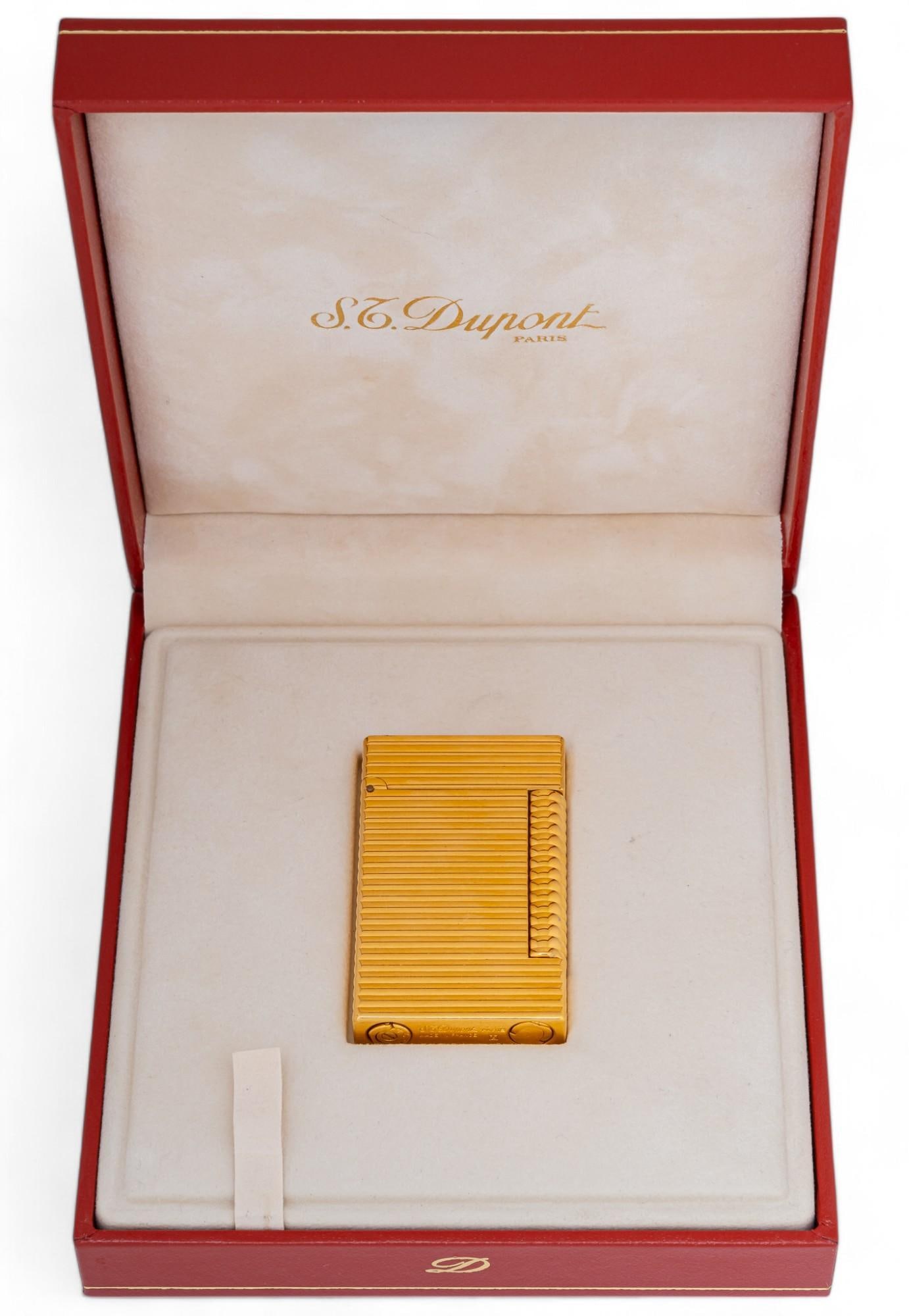 St. Dupont (Paris) Lighter and Red Leather Case: St. Dupont (Paris) lighter and red leather case, number 1365 Provenance: Property from the collection of a San Antonio, Texas lady