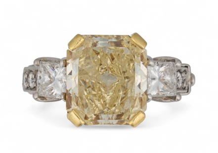 Platinum and 18K 6.84 ct Yellow Diamond Ring: Platinum and 18K 6.84 ct yellow diamond ring featuring central cut cornered rectangular brilliant cut 6.84 ct (clarity SI2) fancy light yellow diamond, semi mount with 1.31 ctw diamonds, two princess
