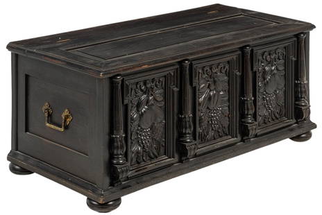 Renaissance Revival Style Trunk: Renaissance Revival style oak trunk, featuring hinged lid that open to interior storage, with heavily carved facade featuring fruit and foliate motifs, with metal handle on each side, supported on