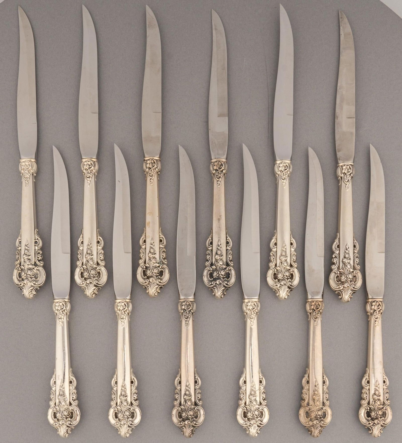 (12) "Grande Baroque" By Wallace Silversmiths Sterling Silver Steak Knives: Twelve "Grand Baroque" by Wallace Silversmiths sterling silver steak knives, marked "Wallace Sterling Handle Stainless Blade"