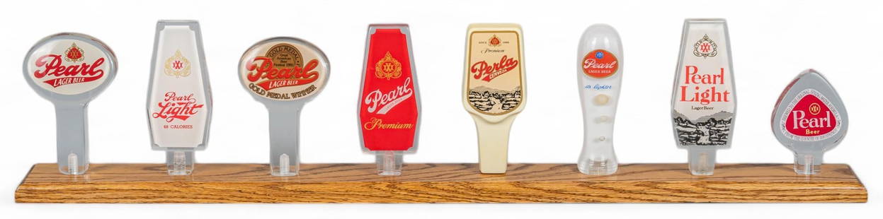 Pearl Beer Tap Handle Display Stand: Beer tab handle display featuring eight variations of Pearl Lager Beer (San Antonio, Texas), including Pearl Lager Beer, Pearl Light, Pearl Premium, and Pearl Cerveza, with others, displayed on