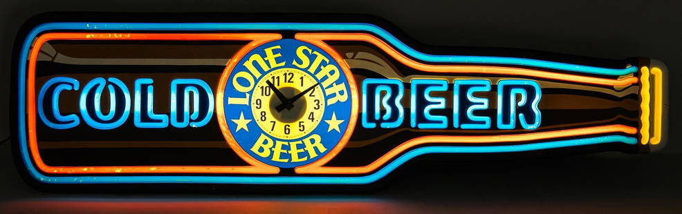 Lone Star Lighted Wall Clock Display: Lone Star Beer lighted wall clock display featuring beer bottle design, circa 1978, in working condition height 14.5 in. x width 51 in. x depth 5 in. Provenance: Property from the collection