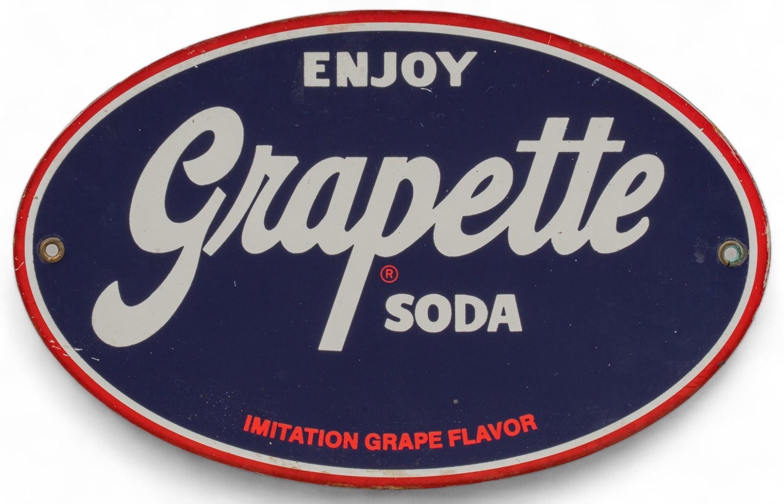 Enjoy Grapette Porcelain Sign: Enjoy Grapette porcelain sign featuring purple background with white and red lettering reading "Enjoy Grapette Soda" 7.5 in. x 12 in. Provenance: Property from the personal collection of a New