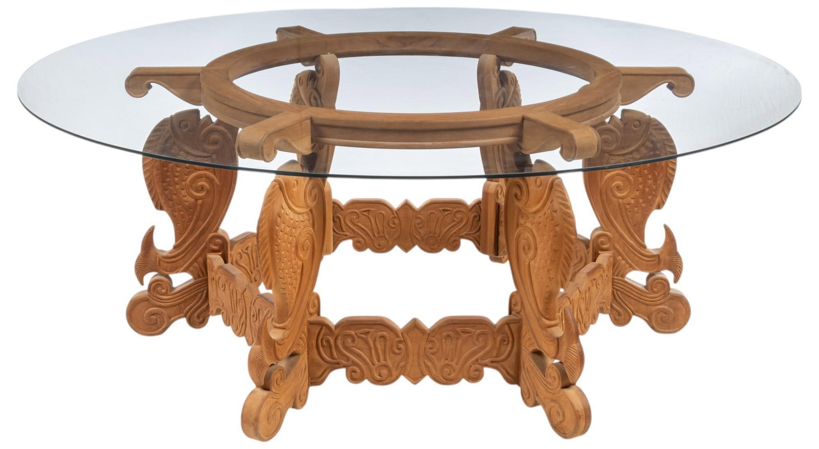 Glass Top Dining Table: Large dining table, having oversized glass top surface and intricately carved wooden frame, with fish motifs on each leg and scrolled feet height 30.5 in. x diameter 80 in. Provenance: Property from t