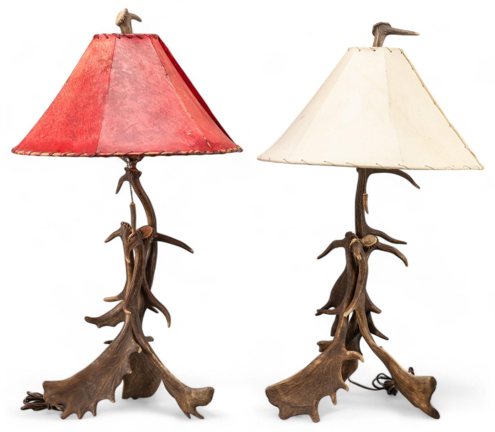 Pair of Antler Table Lamps: Pair of antler table lamps, both featuring animal bone pull strings and animal hide shades, one red and one white height 35 in. x width 20 in. x depth 20 in / largest Provenance: Property from the col