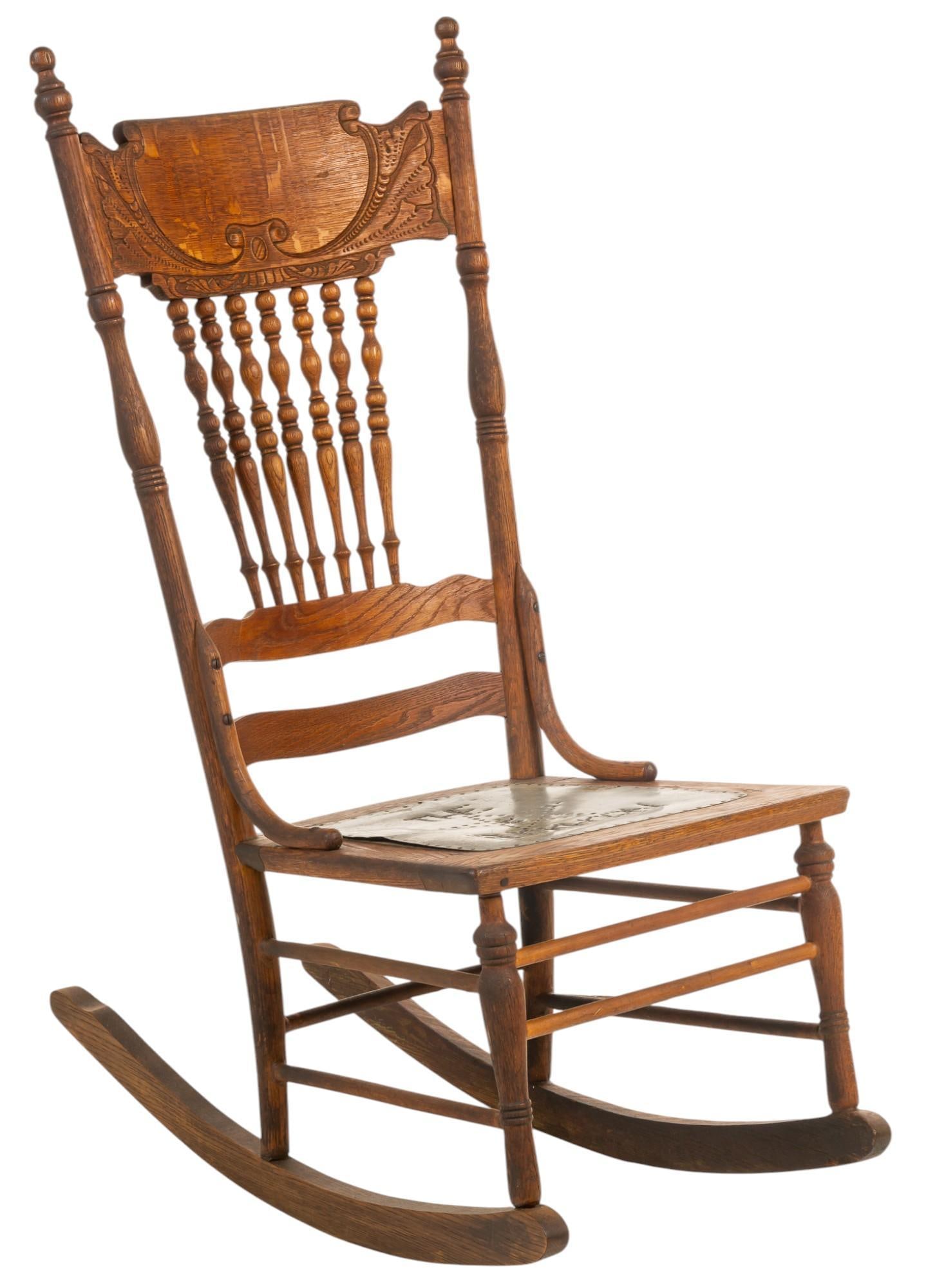 Buckhorn Rocking Chair: Wooden rocking chair with slat back and carved details at top, with metal seat, pierced to read "The Buckhorn" with central star detail, on stretched legs, originally from the Buckhorn Museum 