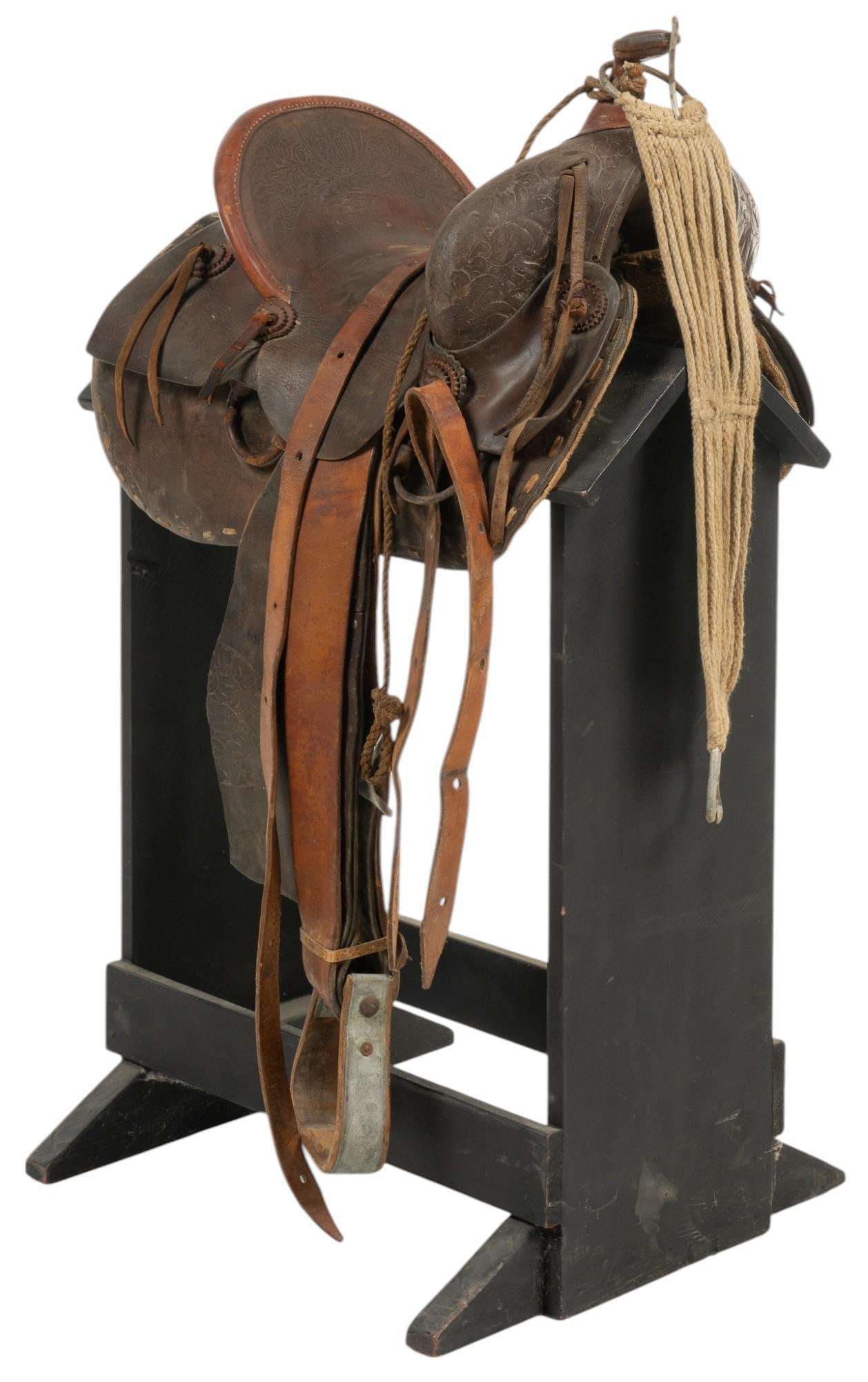 Fraiser Saddle: Fraiser maker marked leather saddle height 40 in. x width 20 in. x depth 25 in. Provenance: Property from the collection of a Castroville, Texas lady