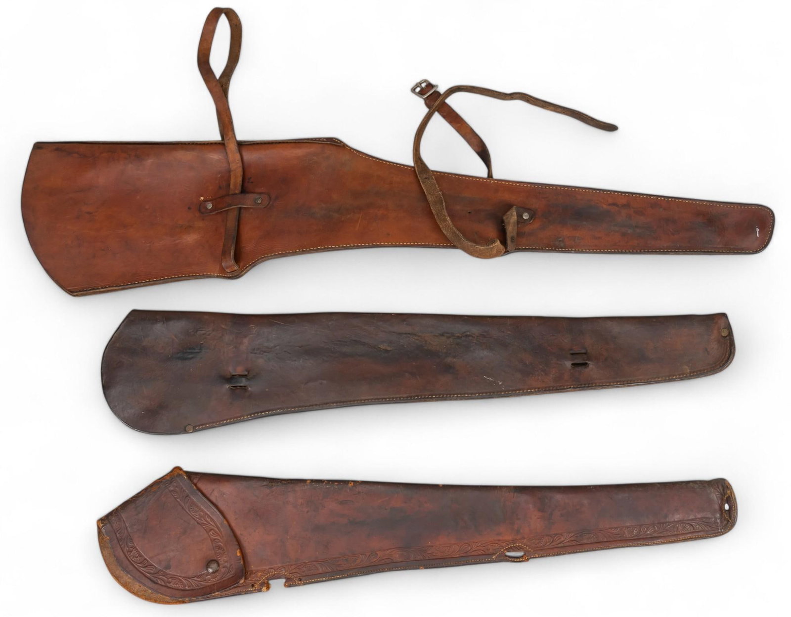 (3) Vintage Rifle Scabbards: Collection of three vintage leather rifle scabbards, includes on marked "Jumbo Brand (Dallas, Texas)", and one marked "HH Heiser" on snap length 38.5 in. x width 8.5 in. / largest scab
