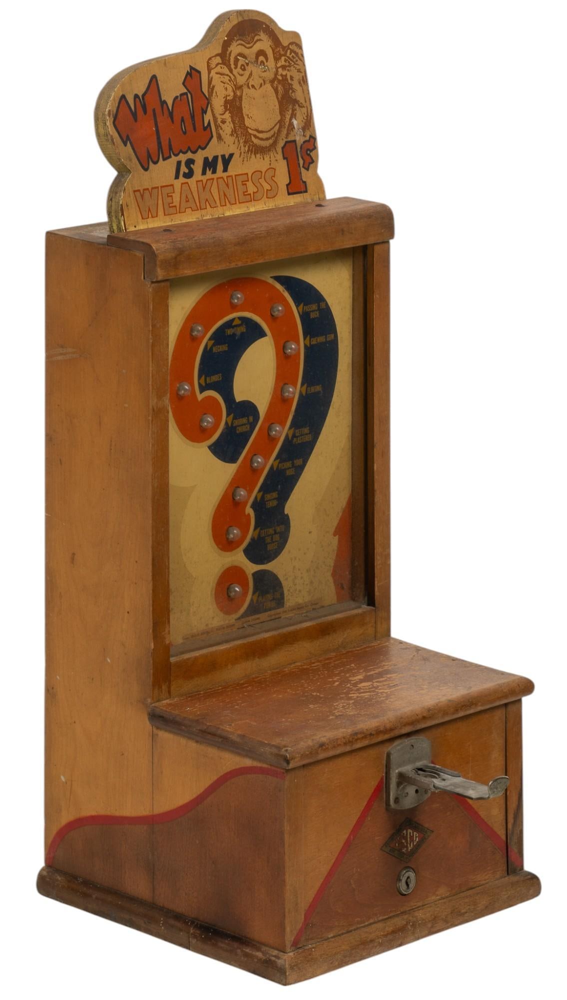 "What is my Weakness" Arcade Game: "What is my Weakness" arcade game, inscribed "Copyrighted 1940 / Exhibit Supply Co, Chicago" height 28 in. x width 12 in. x depth 14 in. Provenance: Property from the collection of a C