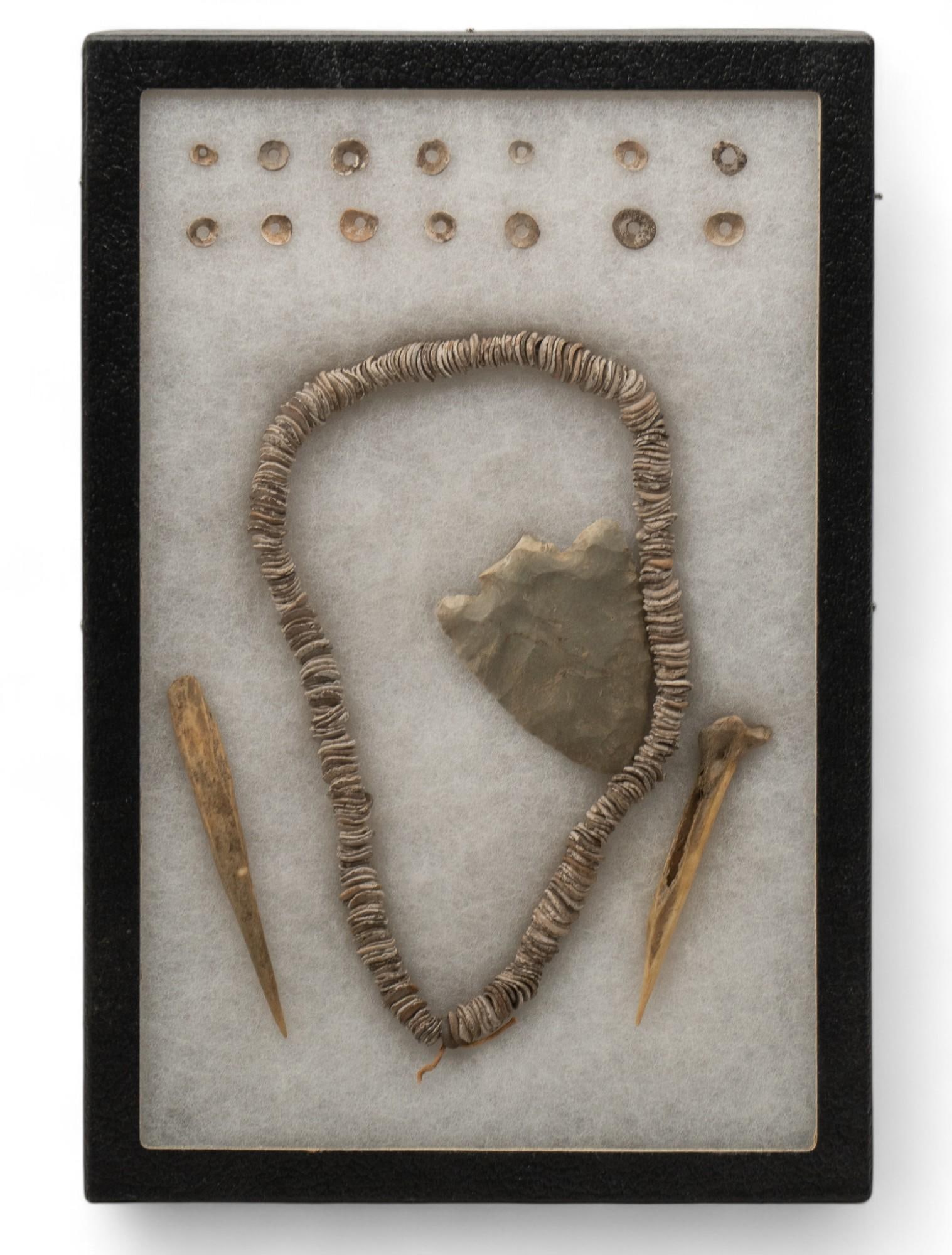 Framed Collection of Native American Primtives: Framed collection of Native American primitives, includes one Snyder Arrowhead Corner-Notch point from the Ohio River Vallery, believed to be Cobden chert, with two bone awls, and string of approximat