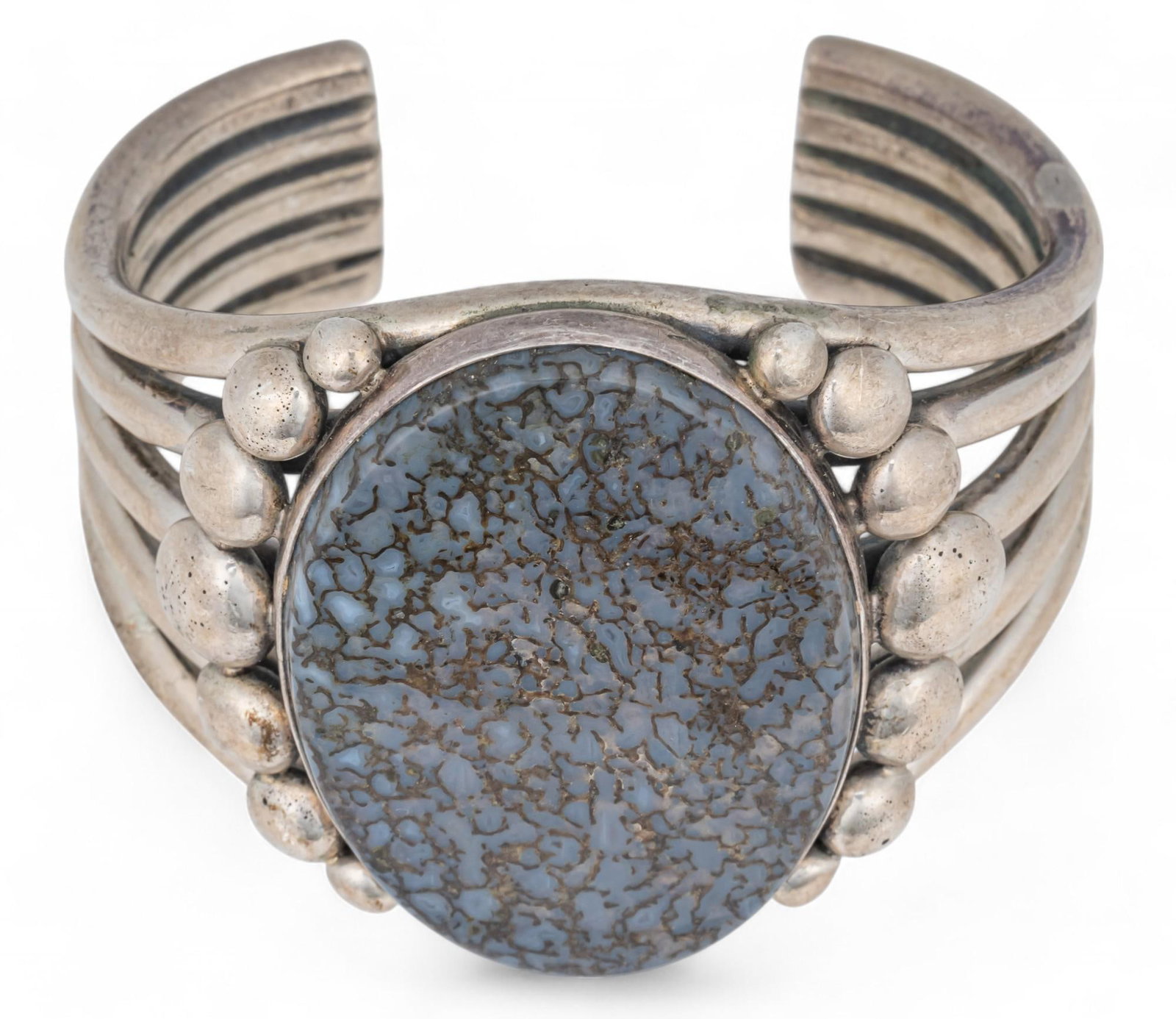 Albert Lee, Agatized Dinosaur Bone and Sterling Cuff: Albert Lee, agatized dinosaur bone and sterling cuff featuring oval inlaid bone detail with geometric band, marked "A. Lee Sterling" circumference: 7 in. Total weight: 4.58 ozt