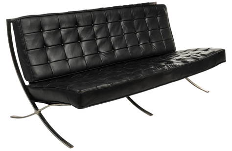 Barcelona Sofa, c.1970s: Barcelona style sofa, in the style of Mies van der Rohe (Germany, 1886-1969) with chrome frame and elastic bands, square patterned black leather cushions, circa 1970s height 31 in. x width 72 in.