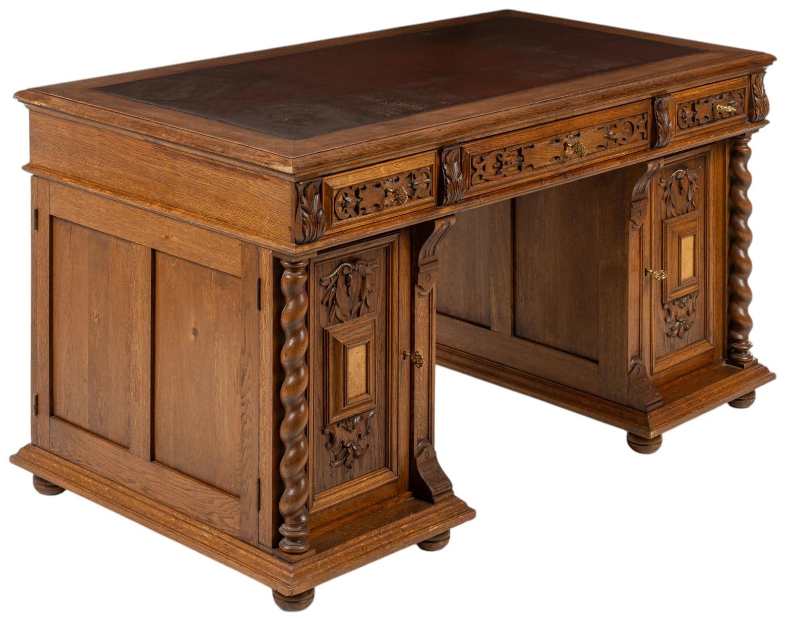 19th C. French Notary Desk: 19th century French notary desk featuring oversize wooden top with reddish brown leather inlay, above three decoratively carved key lock drawers flanked by carved acanthus leaf details, with right dra