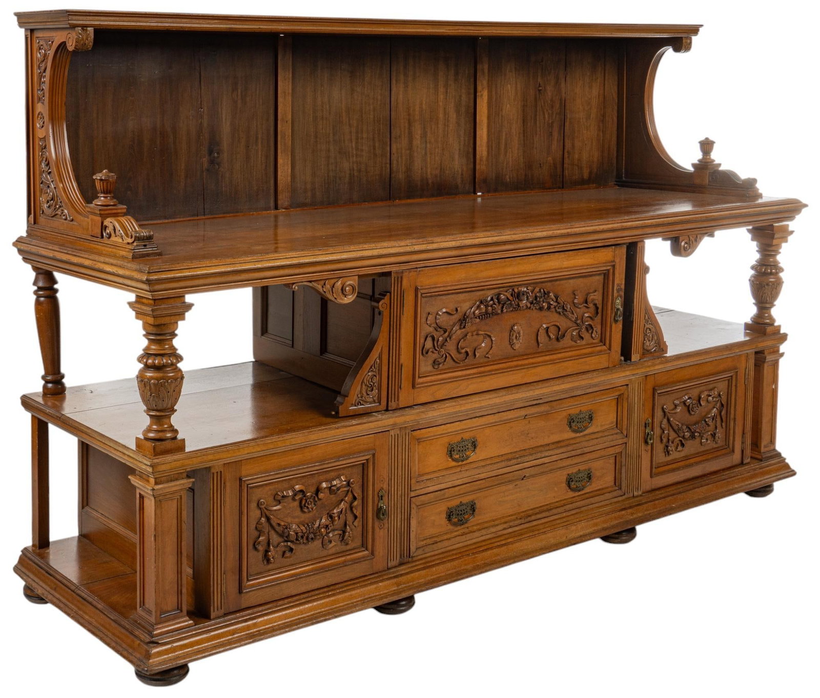 Victorian Carved Buffet: Victorian wooden buffet, featuring upper shelf flanked by curved, intricately carved corbel arches, middle shelf supported by turned pedestal columns with door having carved floral and ribbon motif, b