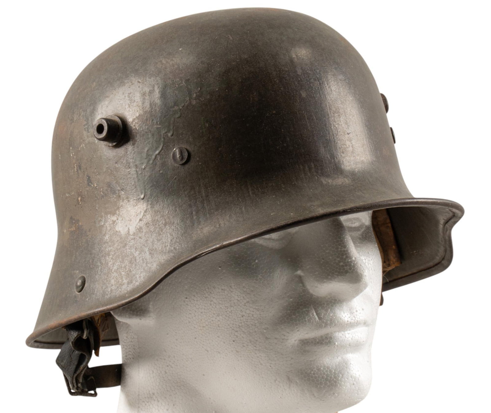 WWI German Imperial M16 Helmet: Includes: -WWI German Imperial M16 helmet: partial liner & chinstrap; decals may have been removed; helmet marked "B.F.64" & "R728"; wear commensurate w/ age; (12 in. x 9.5 in.