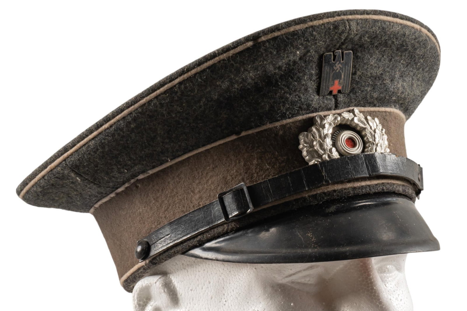 Nice WWII German Red Cross DRK Visor Cap: WWII German Red Cross DRK Visor cap: interior lining damaged & cracked; includes eagle Red Cross pin; (11 in. x 10 in. x 6 in.) Provenance: A San Antonio, Texas estate