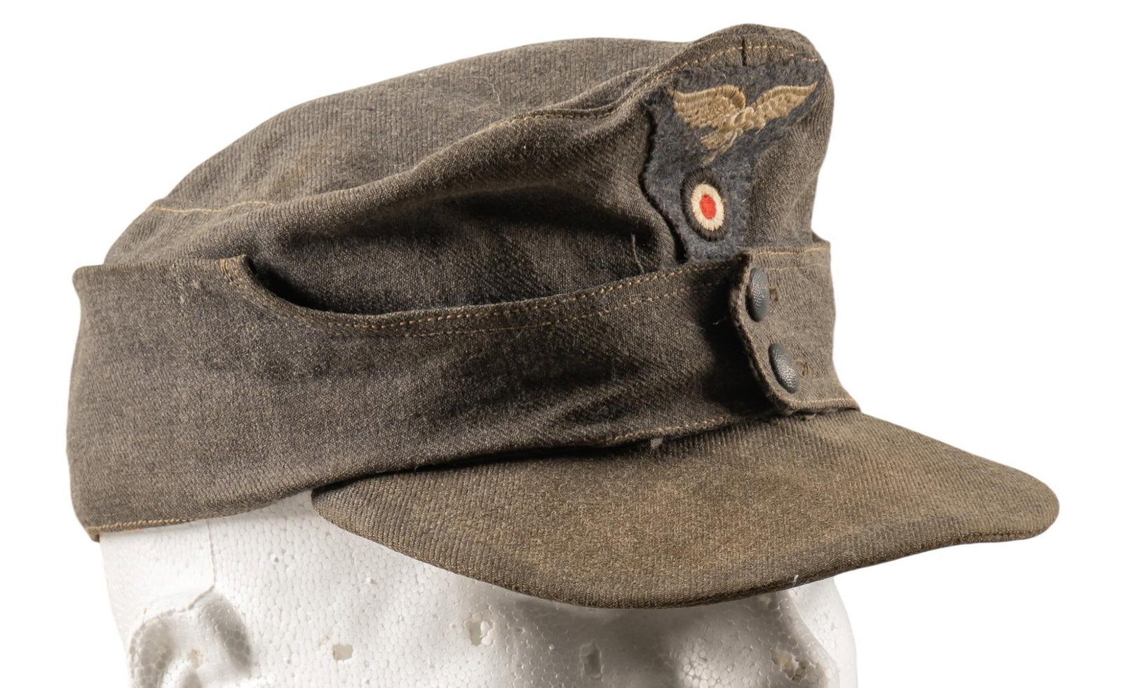 WWII German Heer Field Cap: Includes: -WWII German Heer Field cap: patch insignia; marked "57"; (10.5 in. x 8 in. x 2 in.); dirty/worn; brim is broken Provenance: A San Antonio, Texas estate