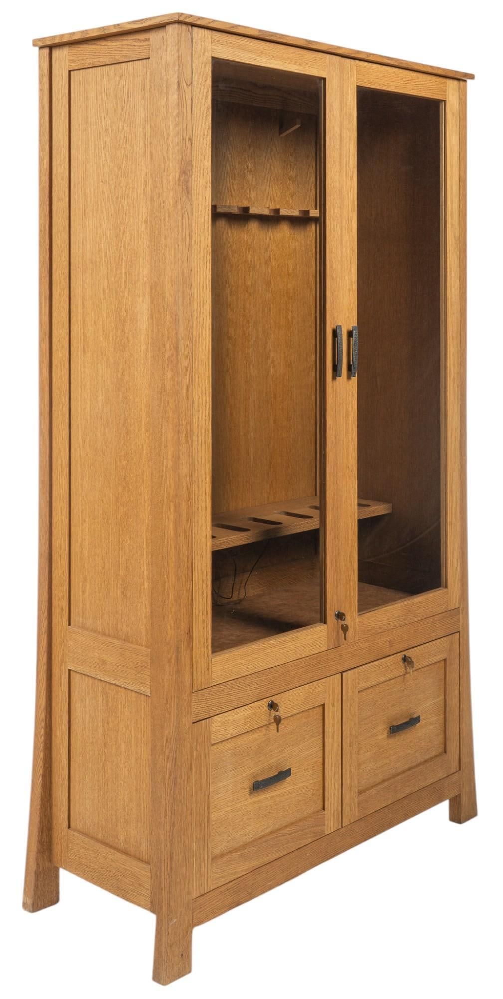 Gun Cabinet: Wooden gun cabinet with pair of key lock glass doors that open to interior with eight distinguished slots for gun storage and three lighting fixture, above pair of drawers with metal pulls and key loc