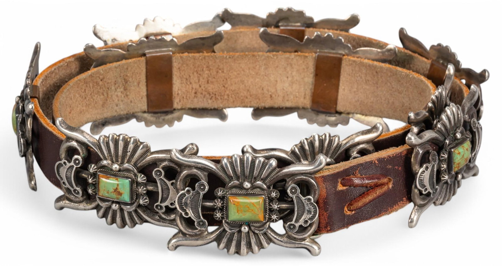 Sterling Silver Turquoise Concho Belt by R. Tom: Sterling silver turquoise concho belt by R. Tom, featuring ten conchos with inlaid turquoise, marked "Sterling R. Tom" Length: 42 in. Total weight: 17.4 ozt Provenance: Property from the colle
