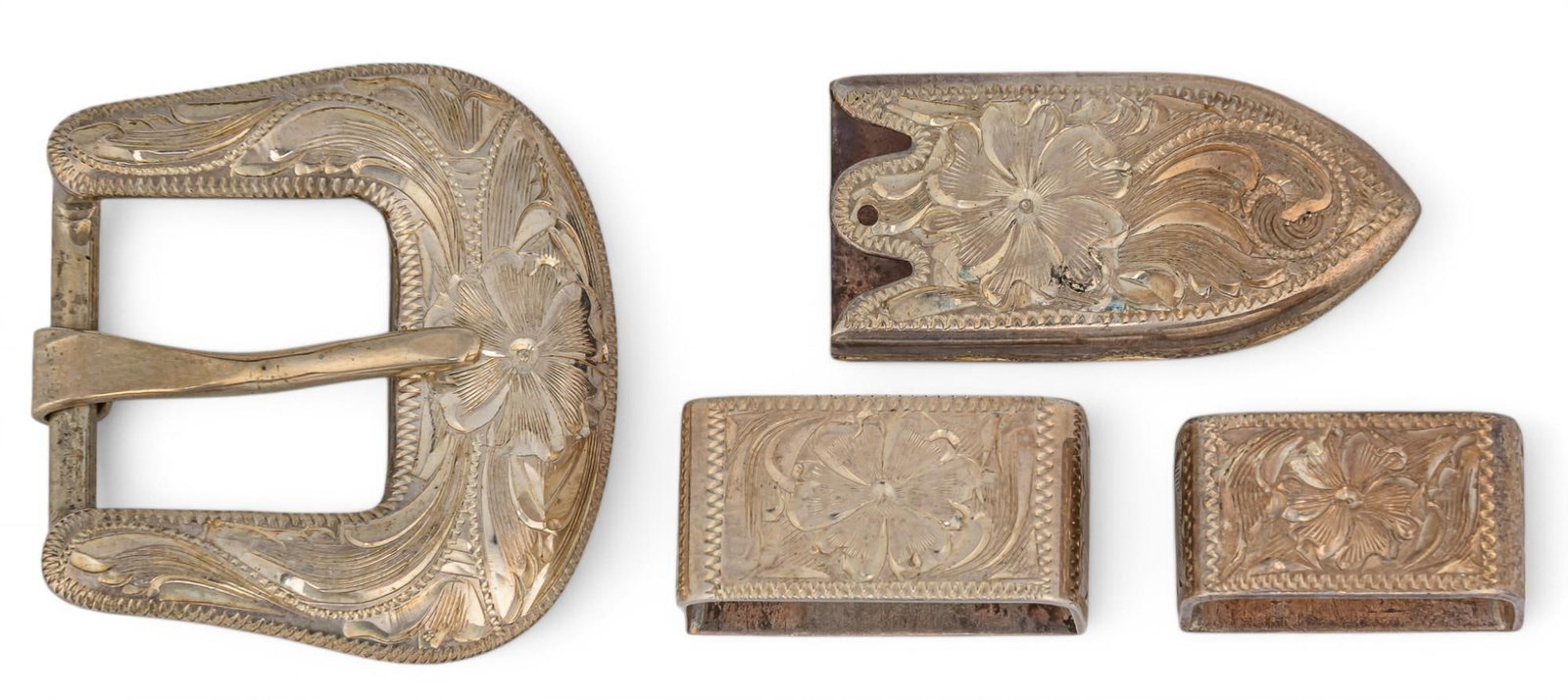 Sterling Silver Belt Buckle and Accessories: Sterling silver belt buckle and accessories Total weight: 0.65 ozt Provenance: Property from the collection of a Pleasanton, Texas lady