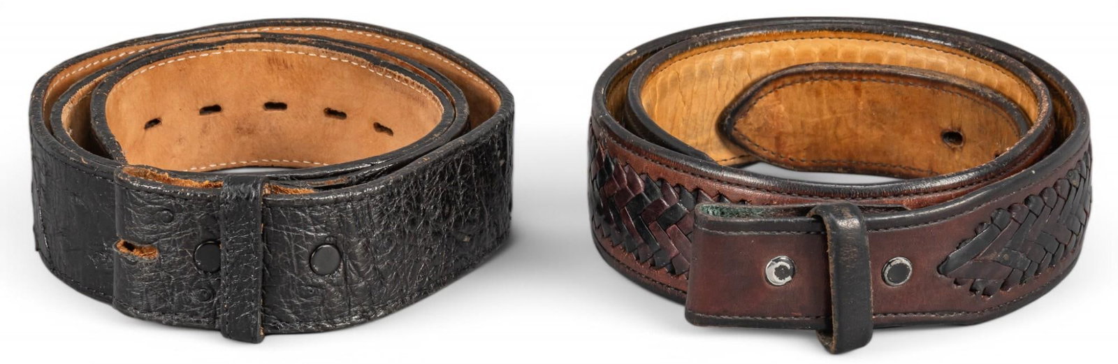 Pair of Leather Belts: Pair of leather belts including Justin black ostrich leather 34 inch belt, dark brown woven 34 inch leather belt, Justin belt marked, one unmarked Provenance: Property from an Alamo Heights, Texas col