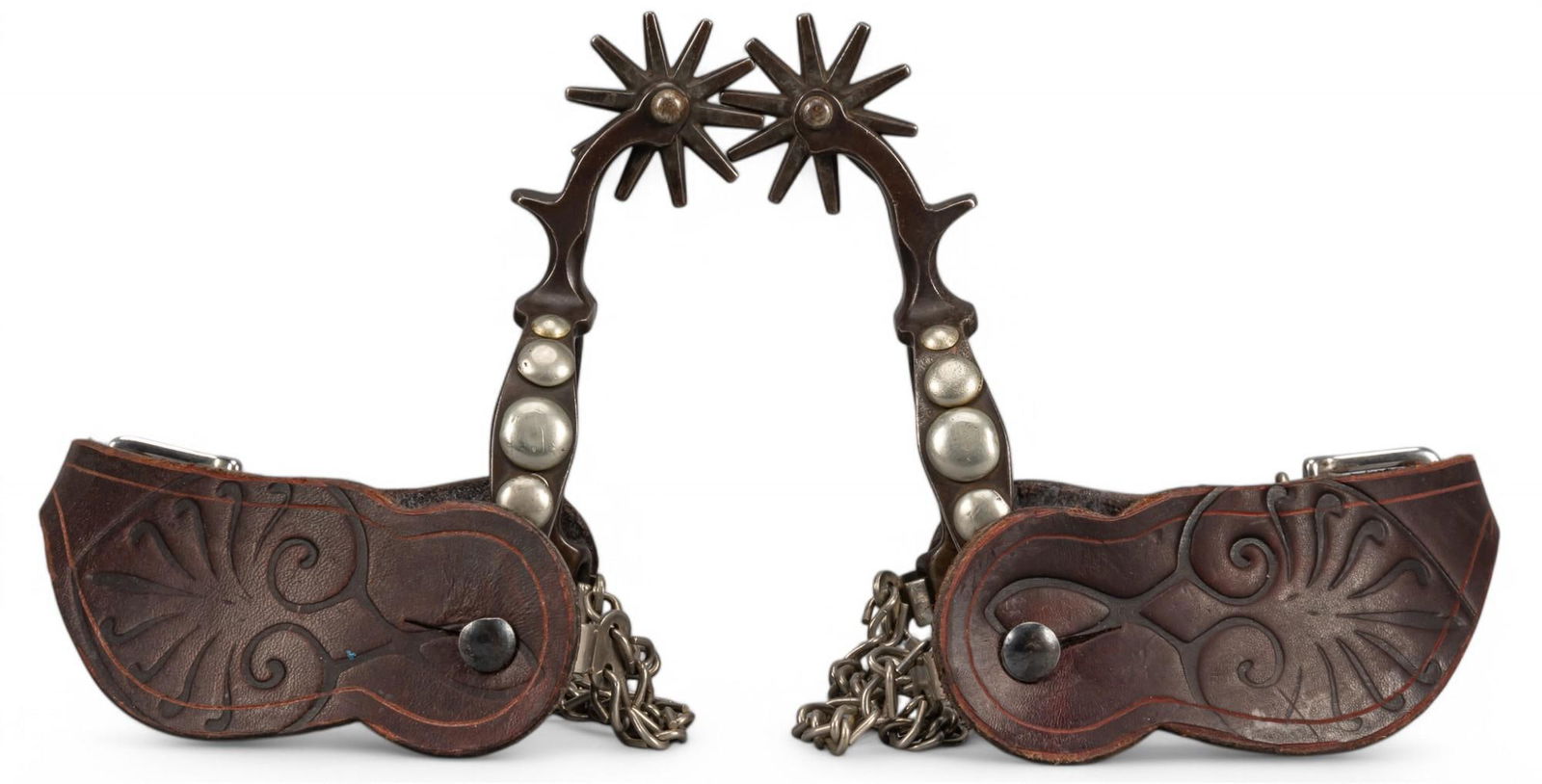 Pair of August Buermann Style Spurs: Pair of early August Buermann style spurs, featuring five spots on heelband, ten-point rowels, and double chains overall spur length not including heel strap / 6 in. heelband width / 3.5 in. rowel